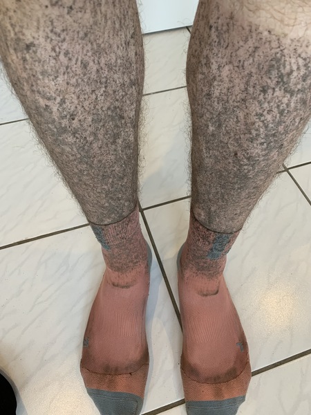 Muddy, dirty legs in red socks